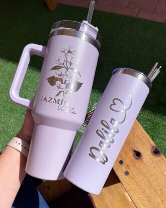 Dos termos personalizados jumbo con agarradera de 1200 ml (40 oz) en color lavanda: uno con "Jazmín" y flores, el otro con "Dalila" y un corazón. Perfectos para disfrutar de tus bebidas favoritas con estilo.