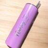 Un vaso de acero inoxidable adornado con purpurina violeta descansa sobre una superficie de madera. Muestra el nombre Nancy Pérez en texto metálico junto con un diseño de corazón y tiene una capacidad de 590 ml. Una pajita de metal se extiende desde la tapa, lo que le suma un toque distintivo a este Termo personalizado con purpurina de 590 ml y 20 oz.